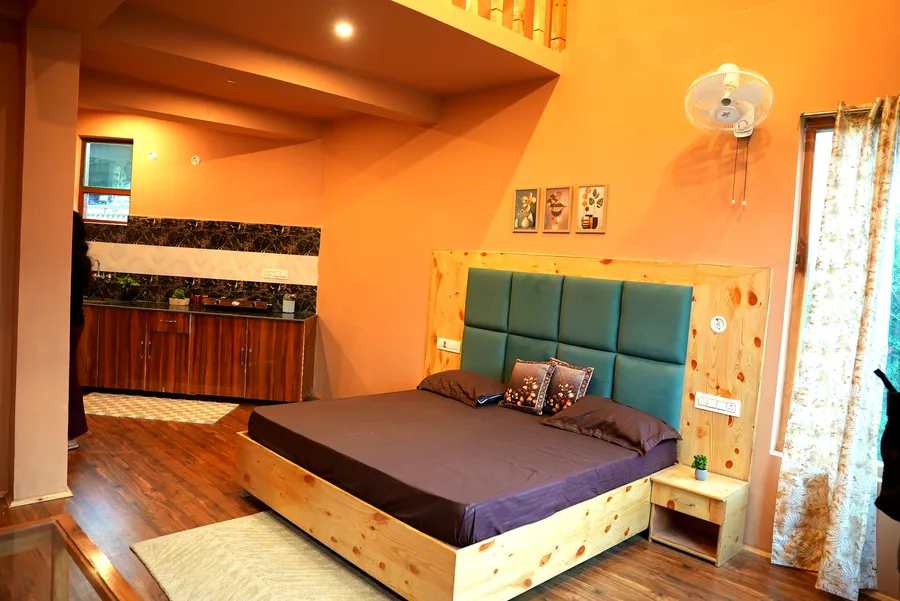 Duplex room with kitchen and teal headboard bed
