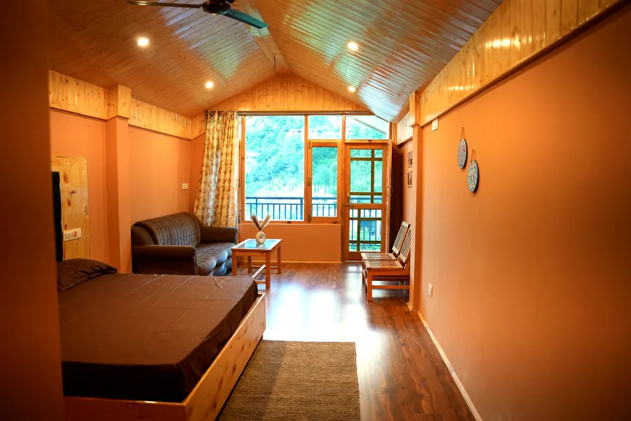 Wide family room with sofa seating and mountain-facing windows