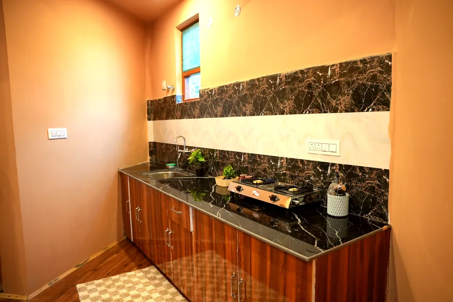 Kitchen counter with marble backsplash and stove