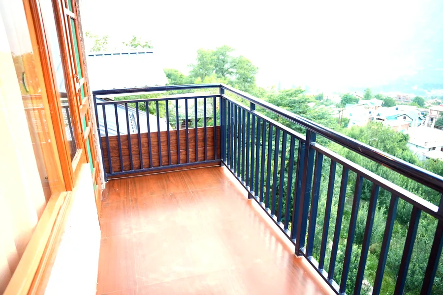 Balcony with valley view and wooden rail
