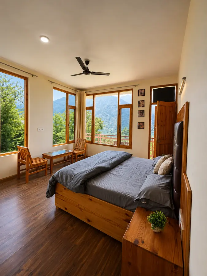 Duplex room in Naggar homestay with large mountain-facing windows